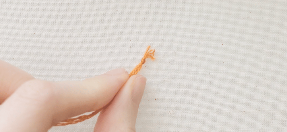 tie a knot at the end of the thread
