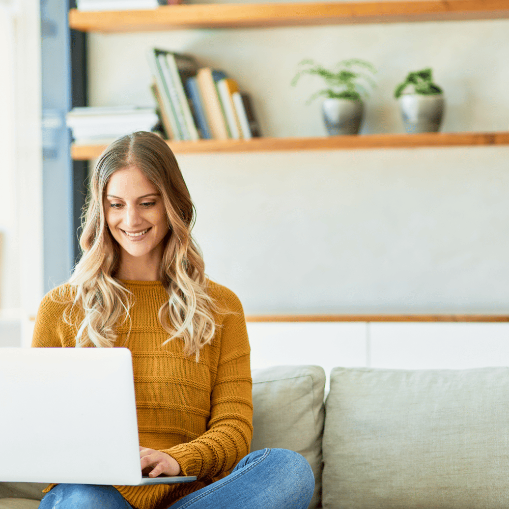 a woman sits on the wing with a laptop in her lap and writes something important
