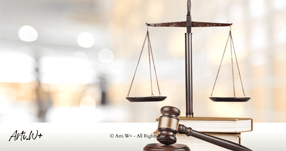 Clip art image of a judge's gavel resting on scales of justice