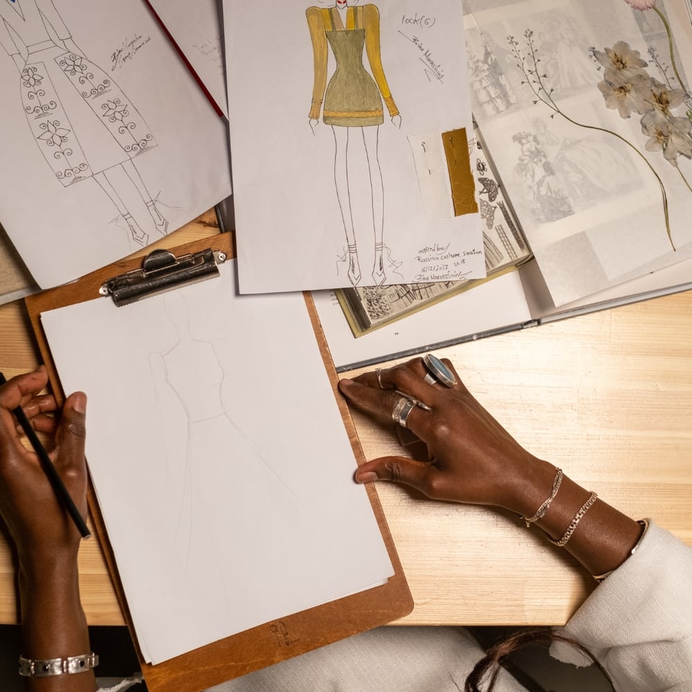 Woman creating a fashion design sketch
