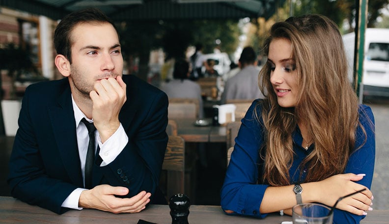 man looking confused with a beautiful woman
