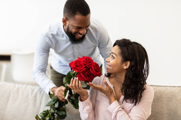 man giving flowers to a woman