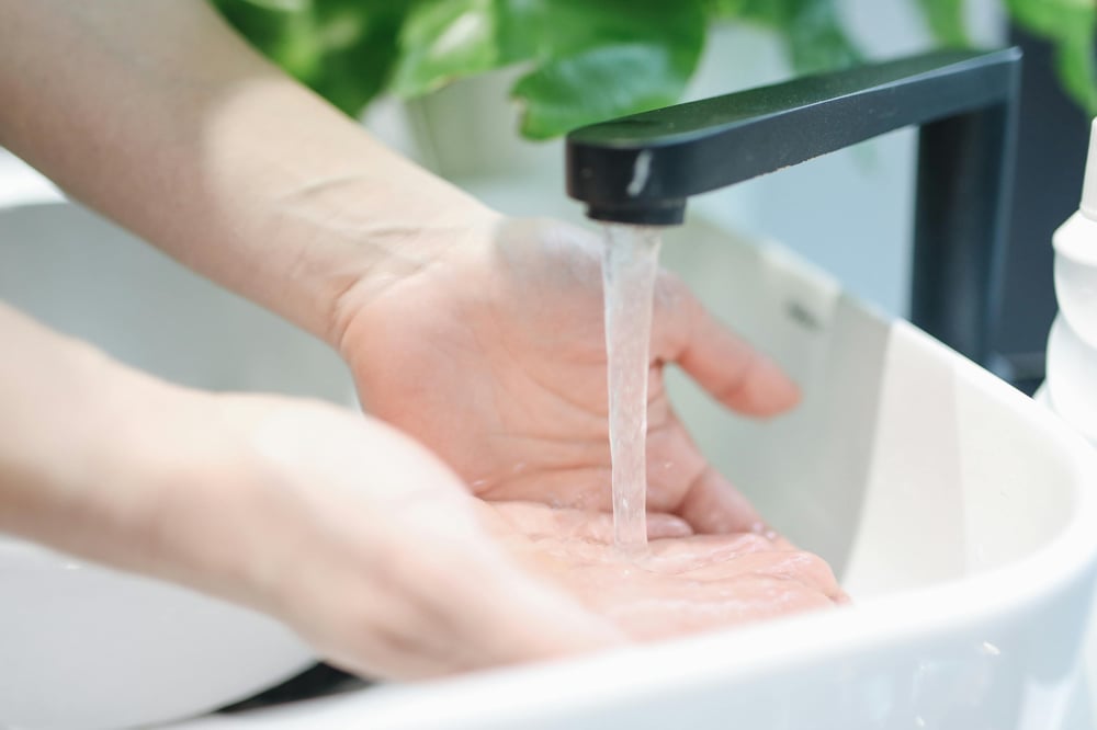 Hands being washed under running water