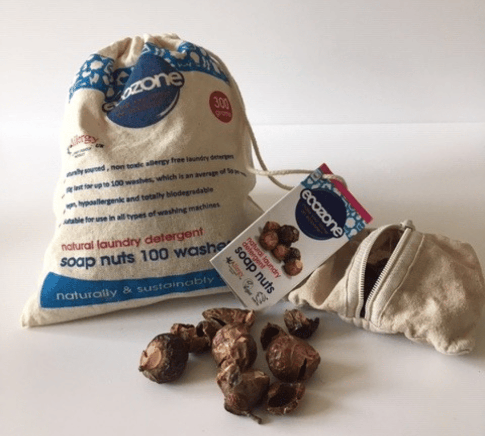 Bag of soap nuts and some soap nuts on the ground.