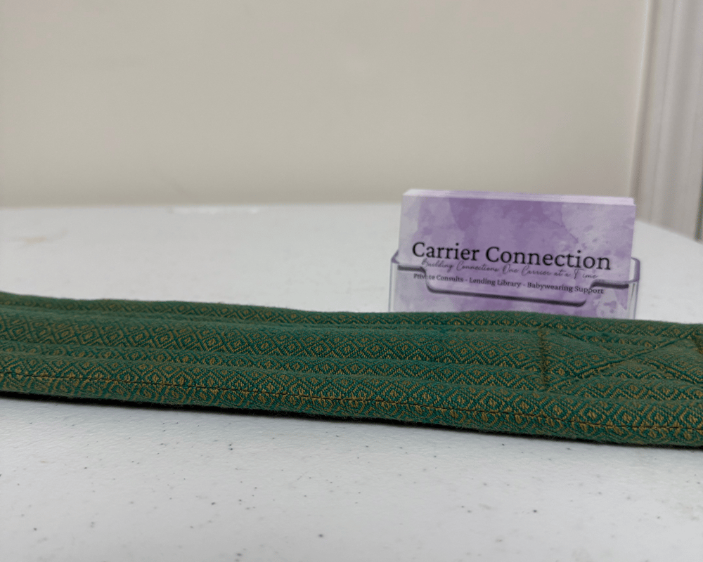 Girasol tie belt on a table focused on the quilted padding and dimensions