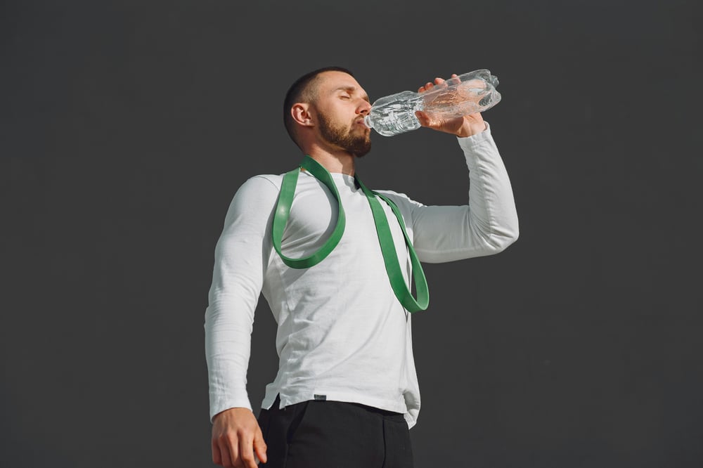 A dehydrated man drinking water