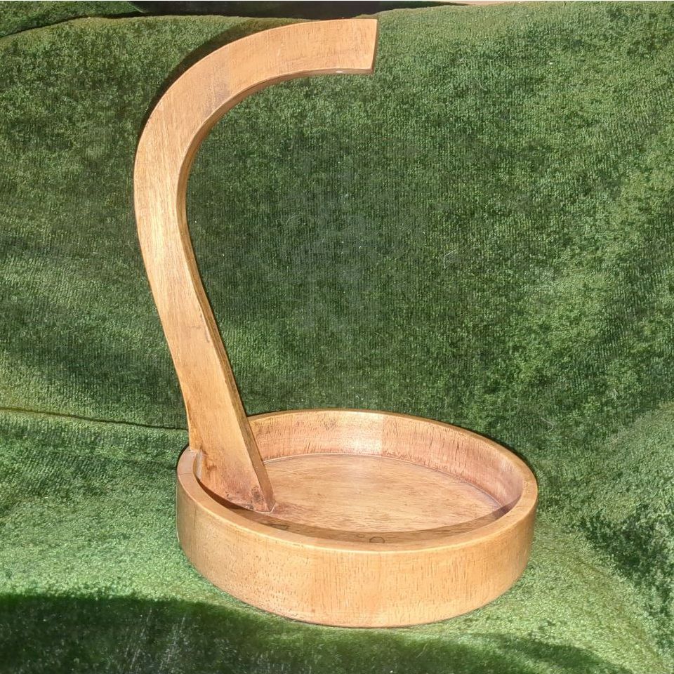 A banana hook made of pieces of curved wood. The base forms a straight-sided, circular bowl.