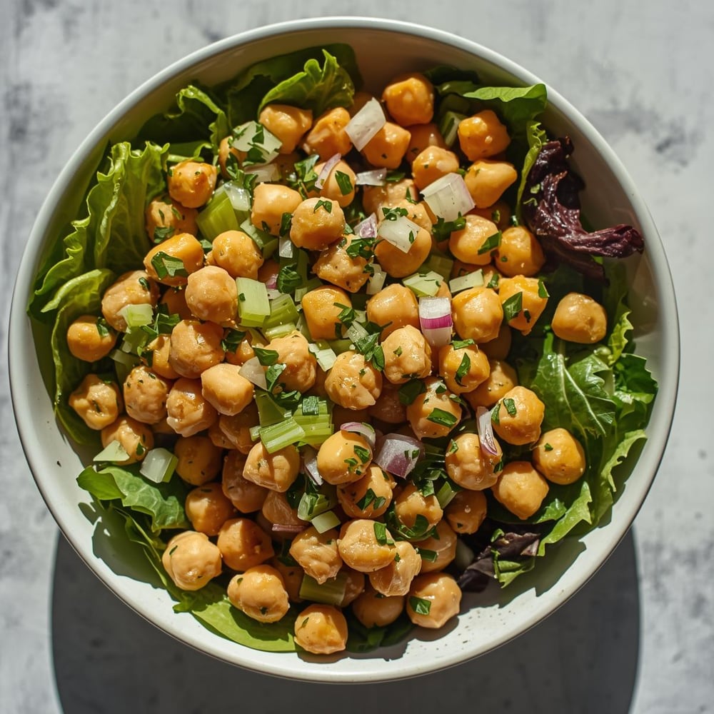 Lunch: Chickpea salad with mixed greens – Chickpeas are an inexpensive source of protein and fiber, perfect for a budget-friendly lunch.