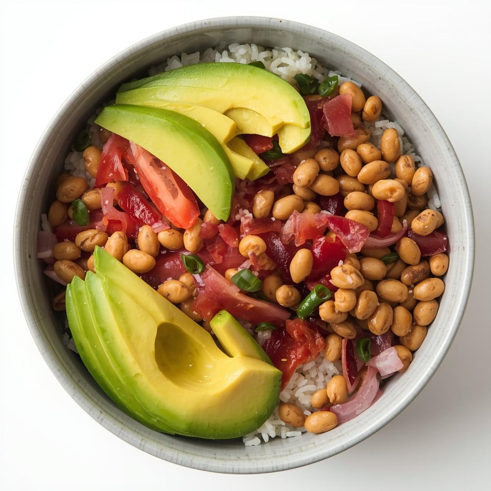 Lunch_ Rice and bean bowl with avocado – A simple, protein-rich meal that’s both filling and affordable.