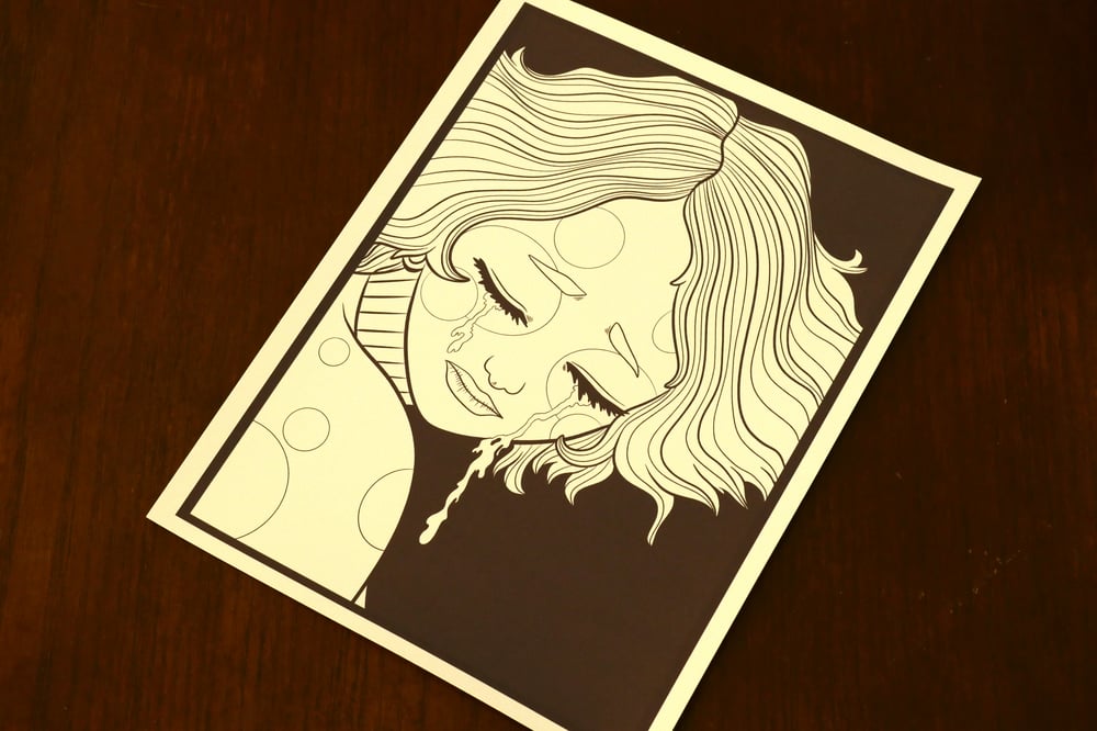 A black and white coloring sheet showing a crying clown.