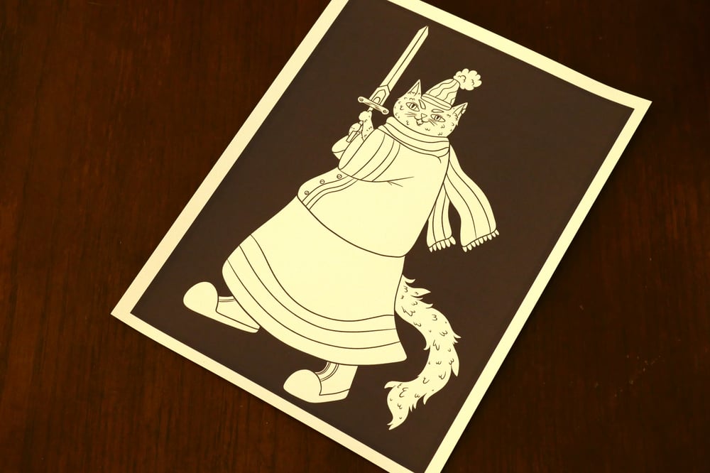A black and white coloring page showing a cat holding a sword.