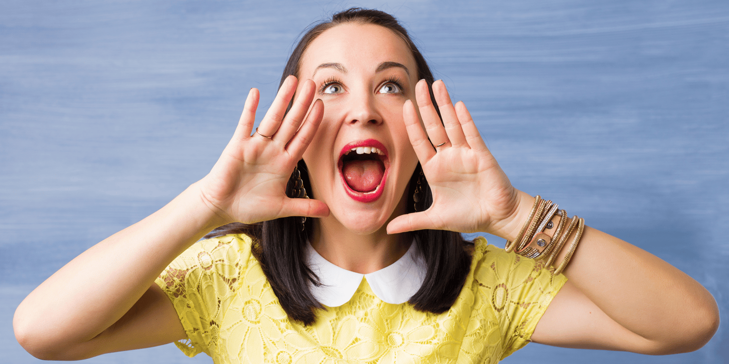 woman placing hands in front of mouth appearing to shout