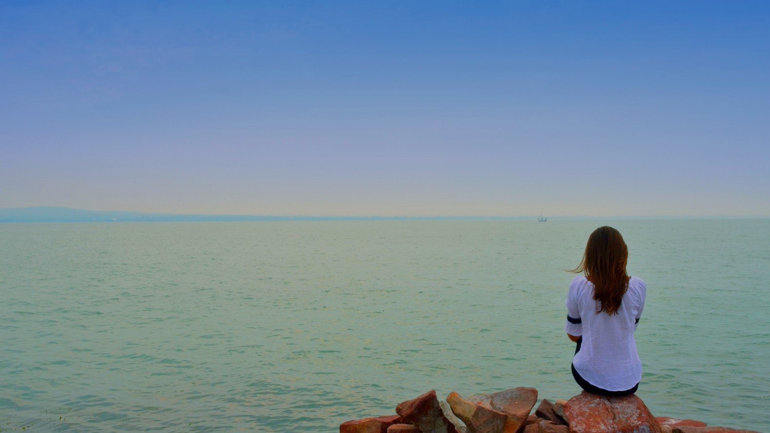 Girl sitting overlooking the sea