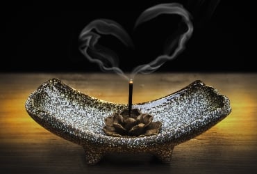 insence burning in a pine cone forming a heart