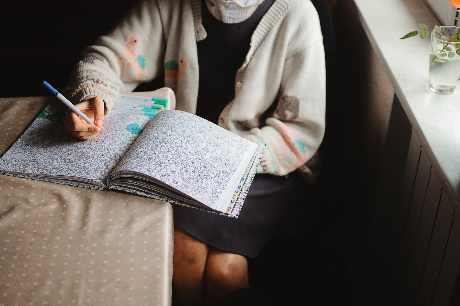 child coloring in a book, colorful, happy