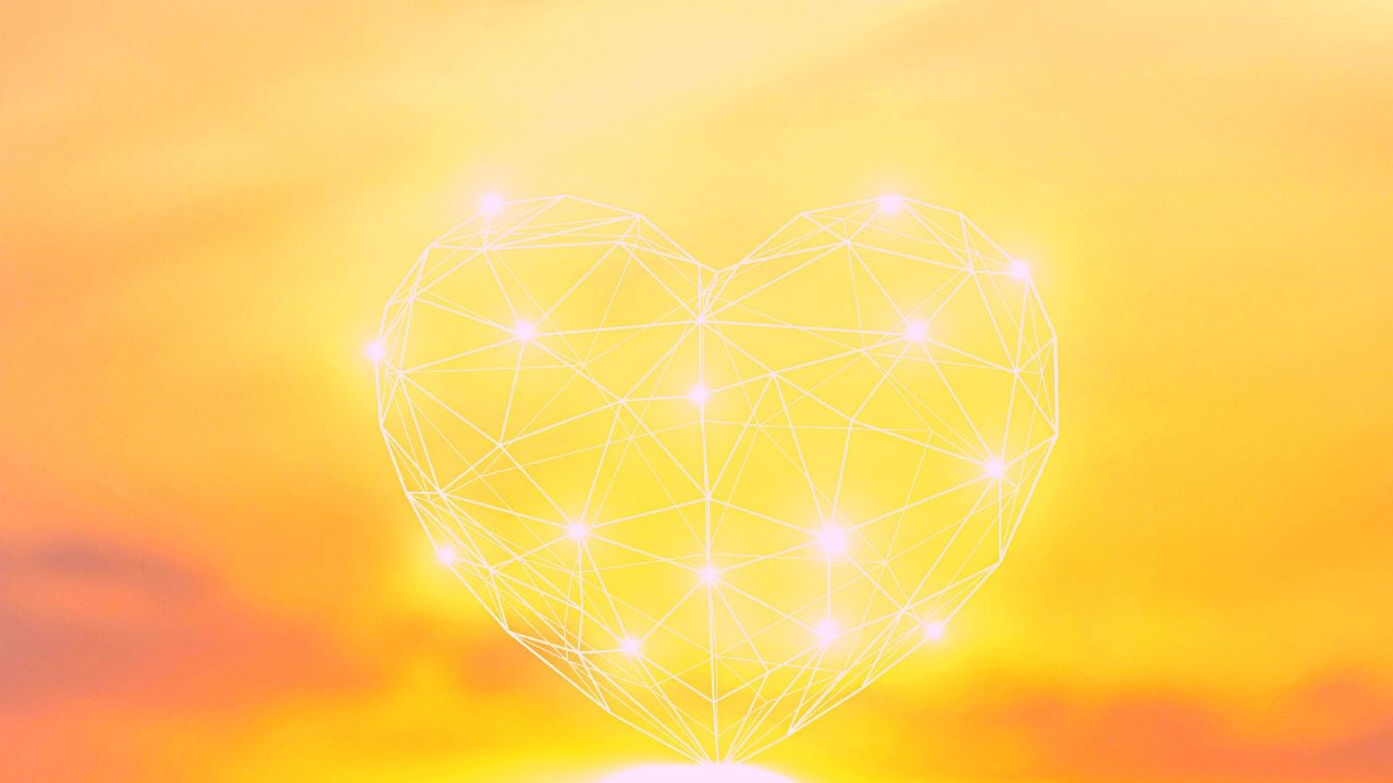 A fairy light heart in front of a sunset