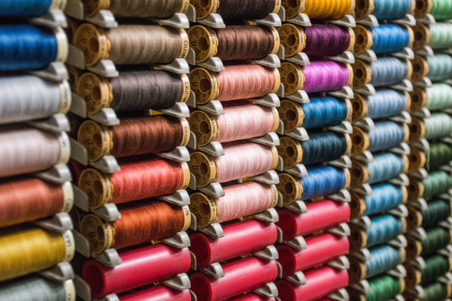 Spools of Thread on a stand in a store - Photo by Hector J Rivas