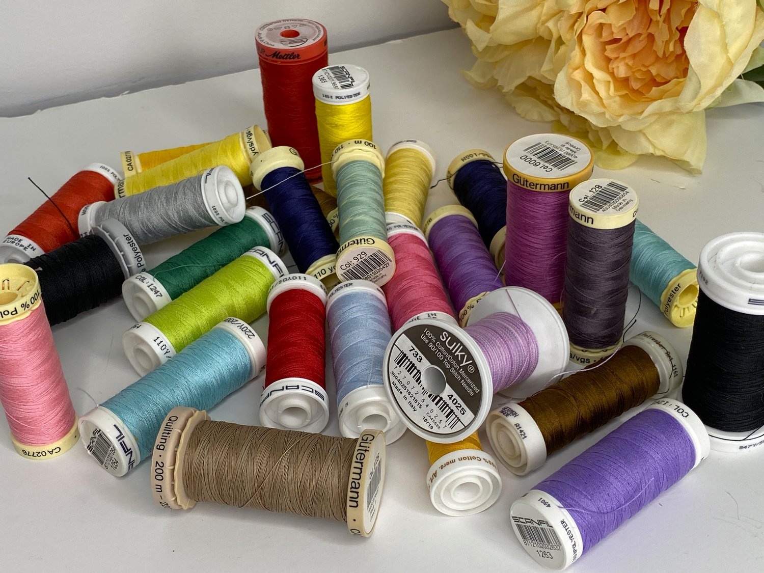 My Threads were always breaking when I was sewing, until I switched to using better quality threads. The image shows my own collection of threads now that I am using higher quality including Sulky, Aurifil, Mettler, Scanfil and Guttermann Thread. I am not loyal to any one brand.