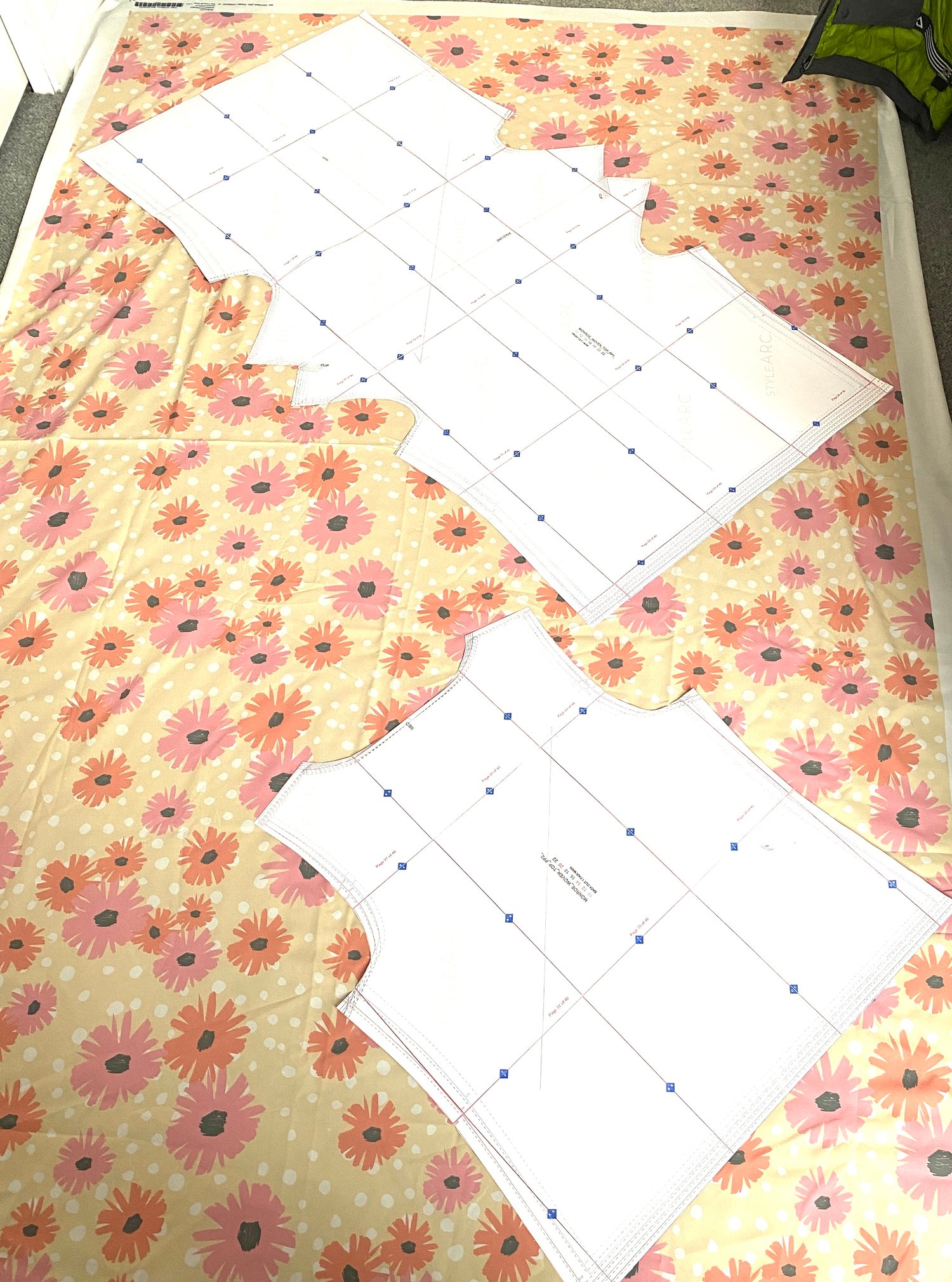 I had to lay the fabric and pattern pieces out on the floor of my bedroom to have enough space! Here is the Poly de Chine Fabric with my design “Blooming Blossoms”, pinned to the pattern pieces and ready to cut.
