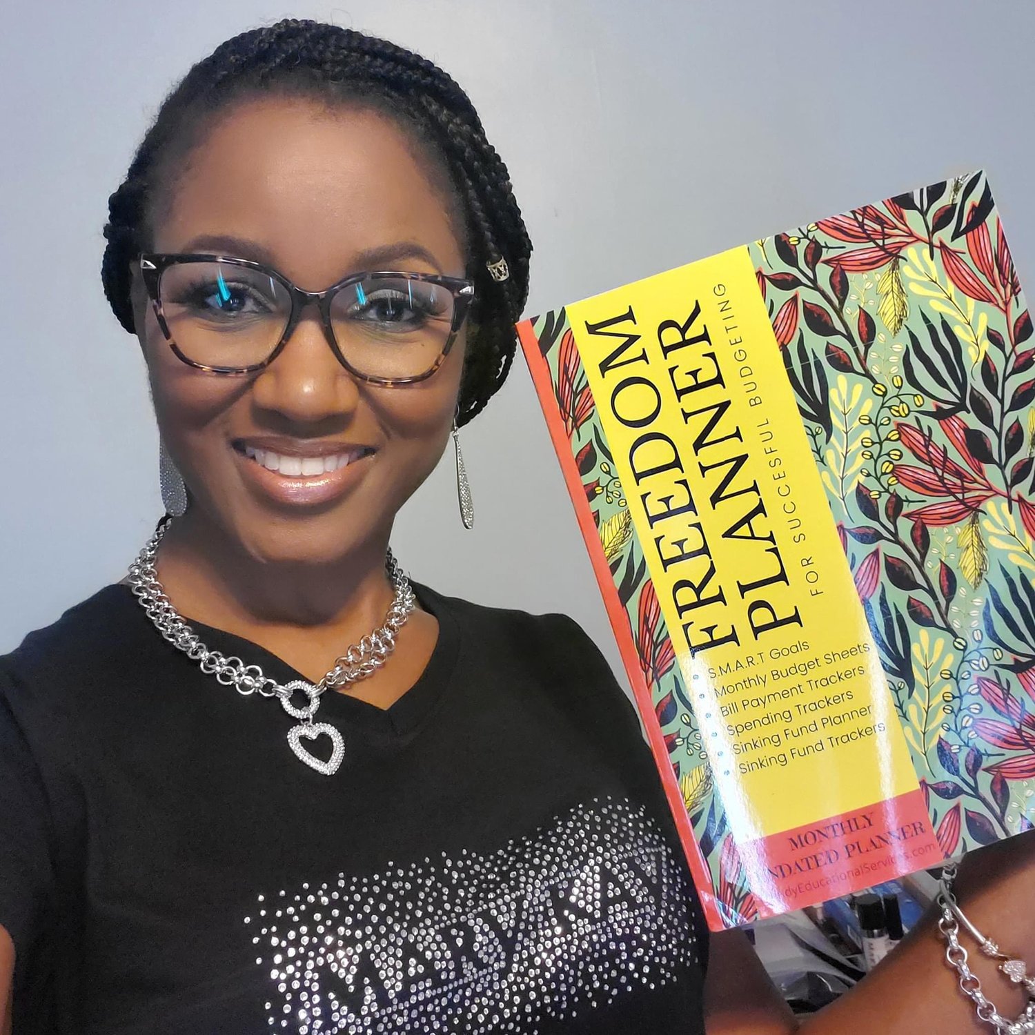 Happy Black Lady Customer Holding The Freedom Planner. Plan Your Freedom:https://payhip.com/b/Krfi2