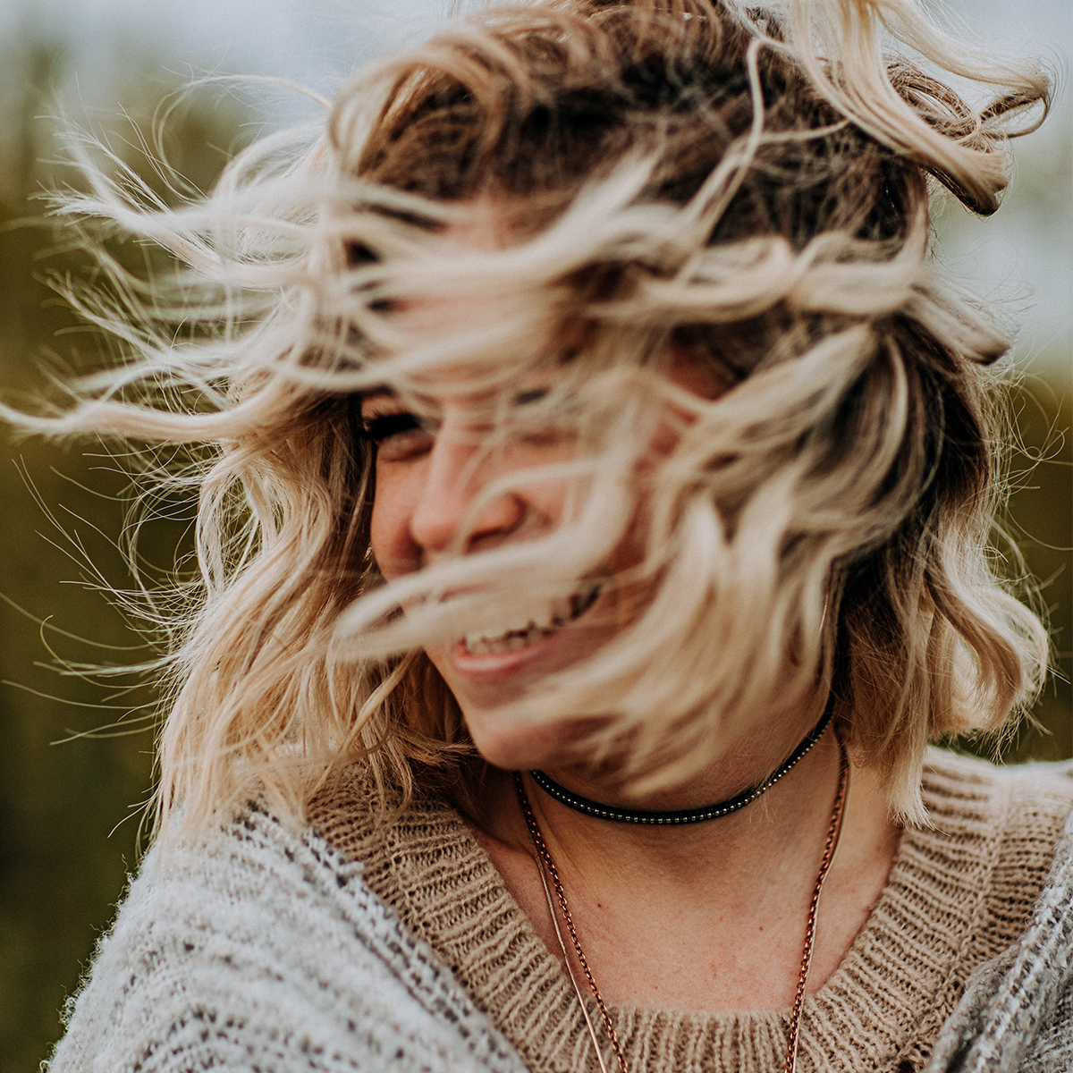 woman smiling and tossing her hair