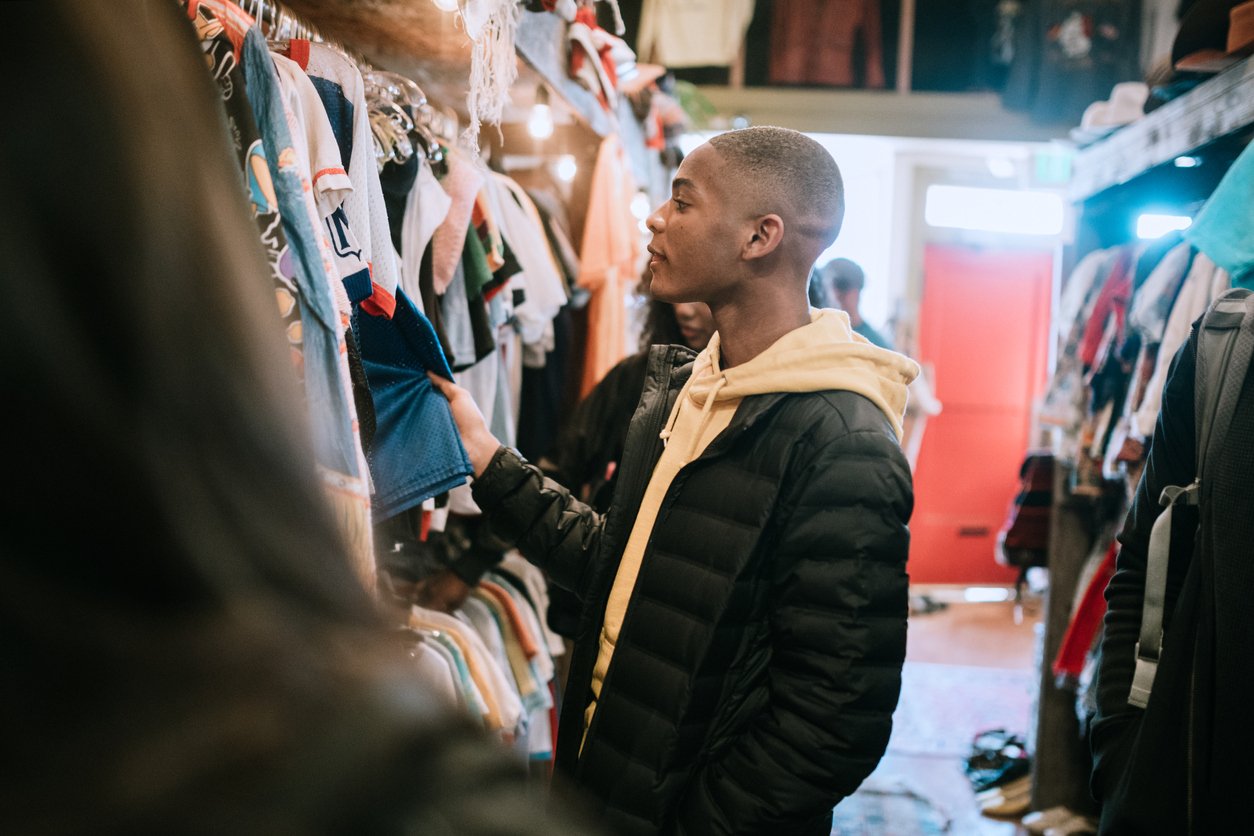 Male shopping for clothes in store