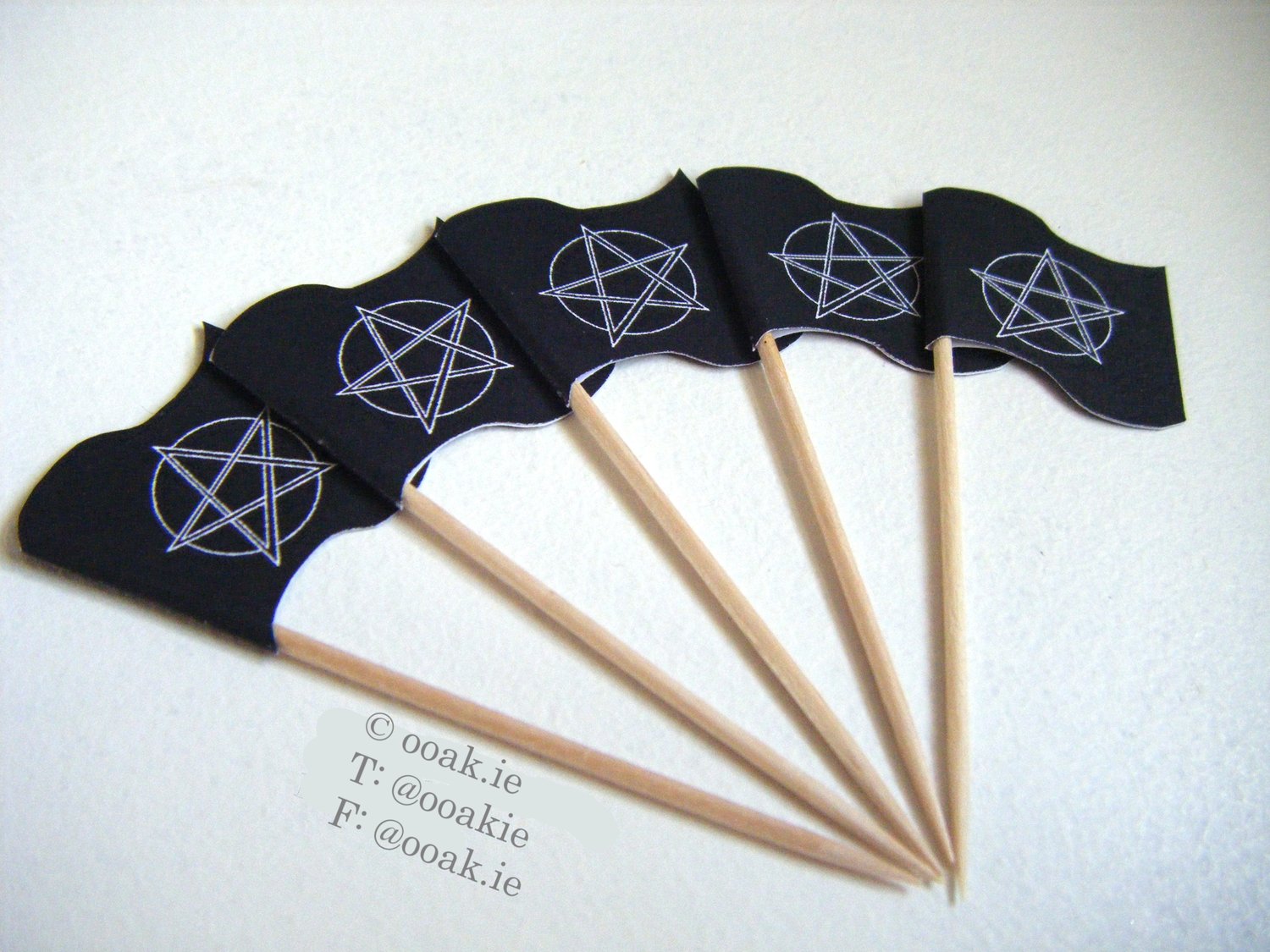 Printable sheet of mini Pentacle flags with a lunar eclipse background, white on black, shown as DIY gothic cupcake toppers.