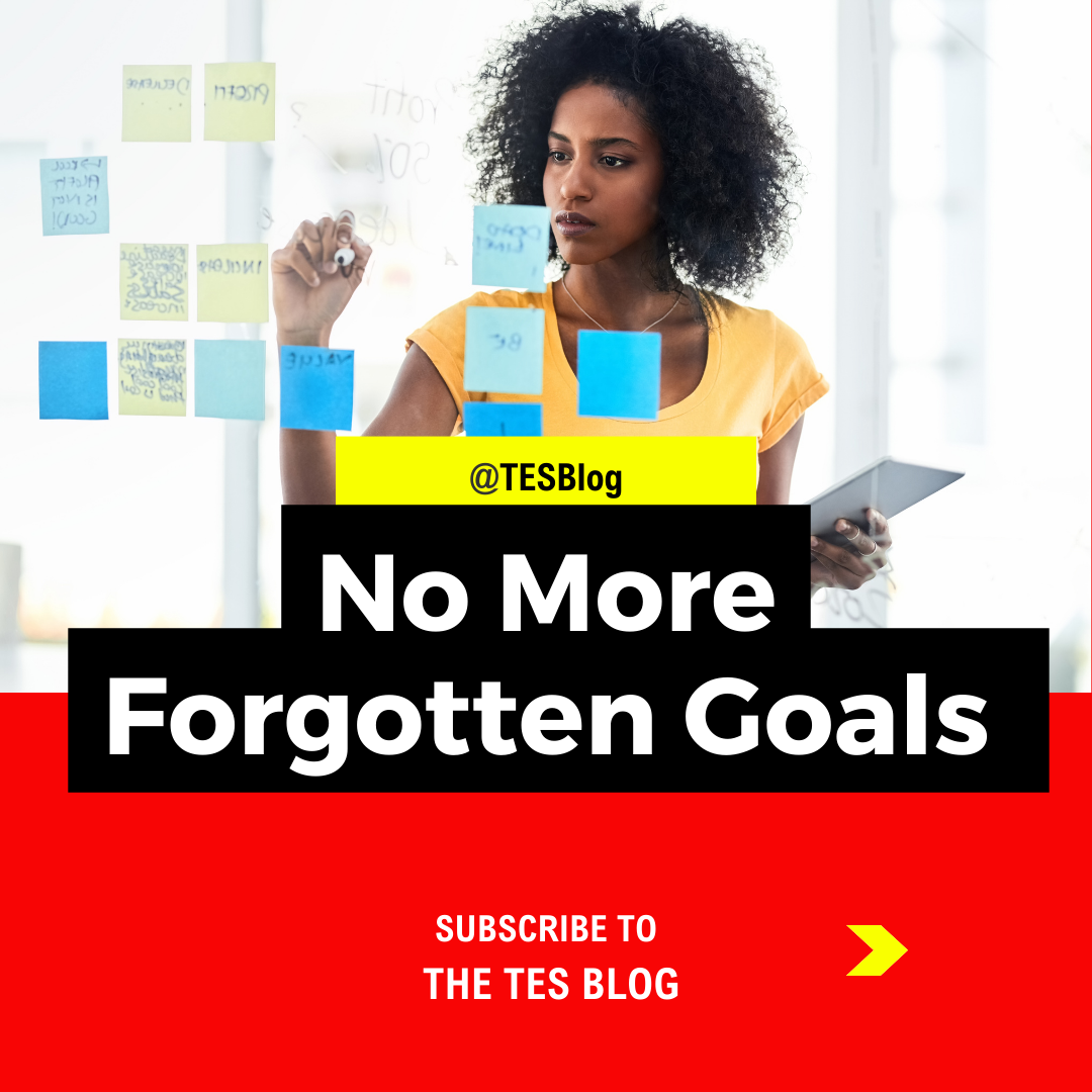 black woman writing on sticky notes planning her freedom and goals at The TES blog.