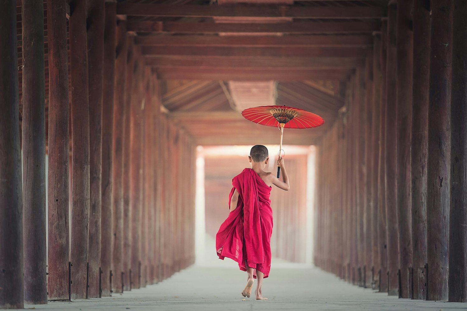 Girl walking through archeways in Asia.