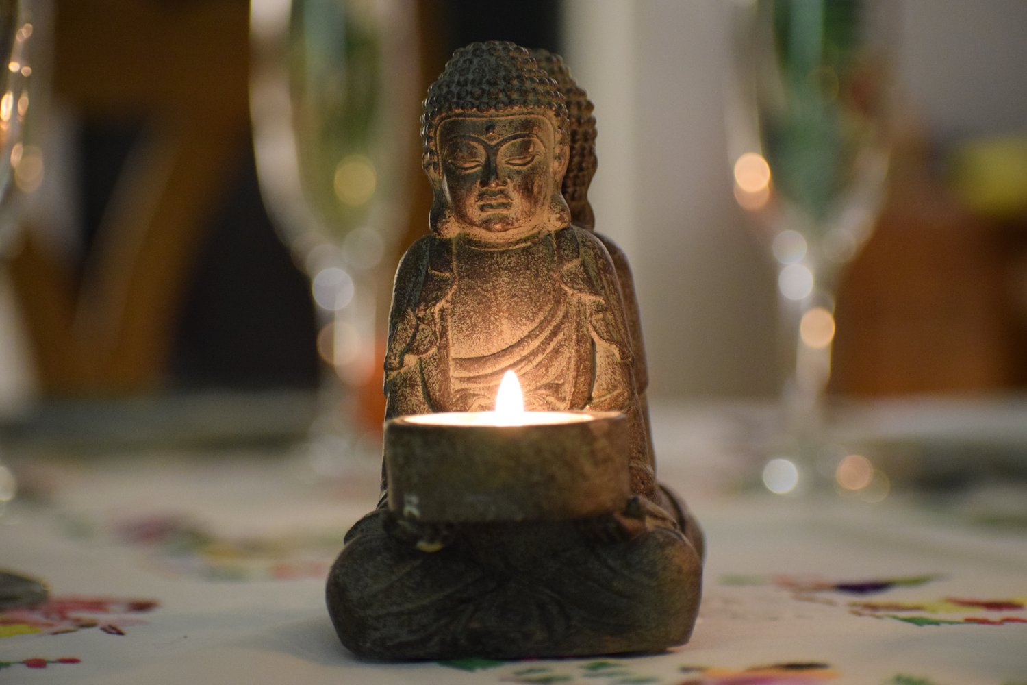 buddha figure with candle burning