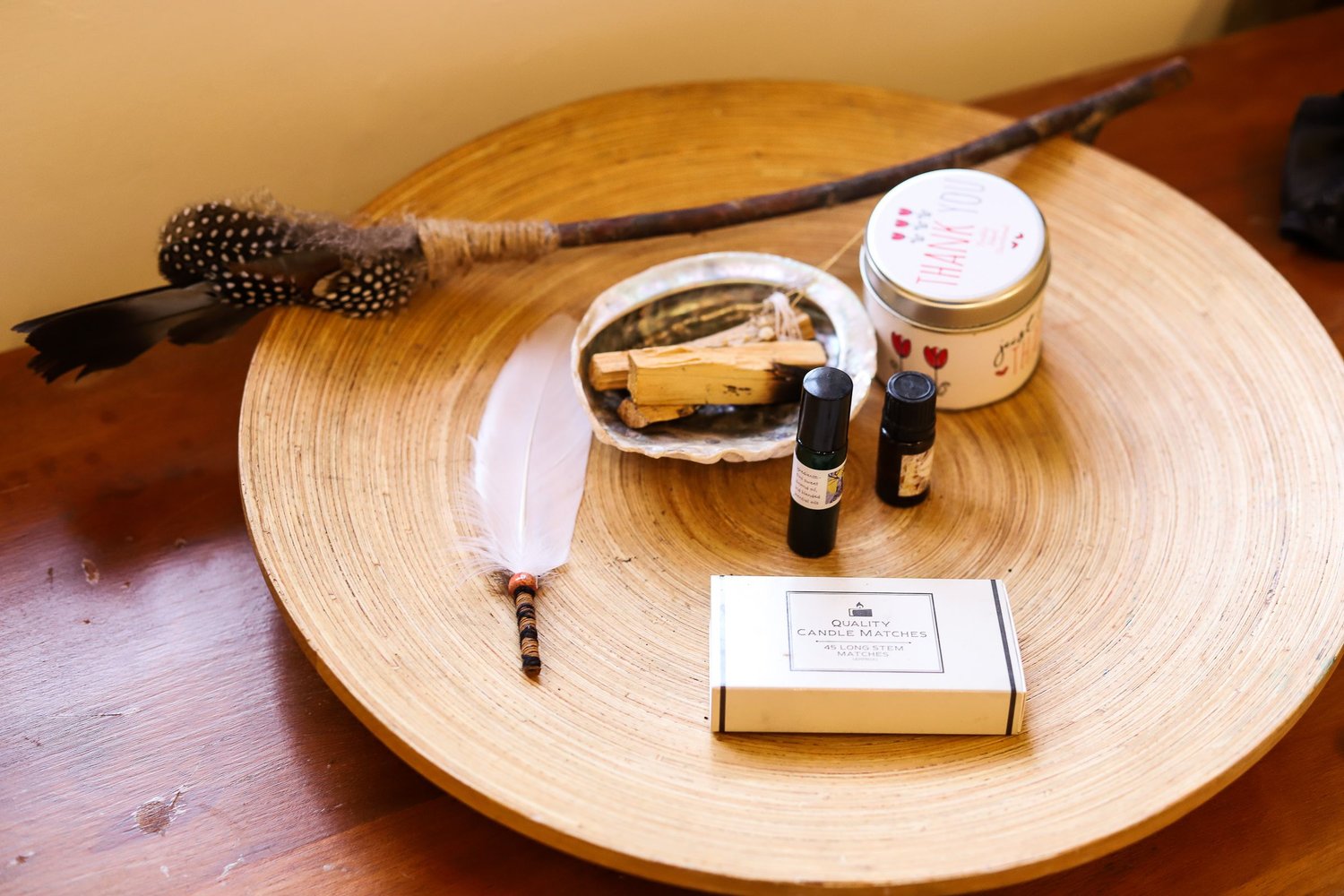 altar with feather smudge candle and shell