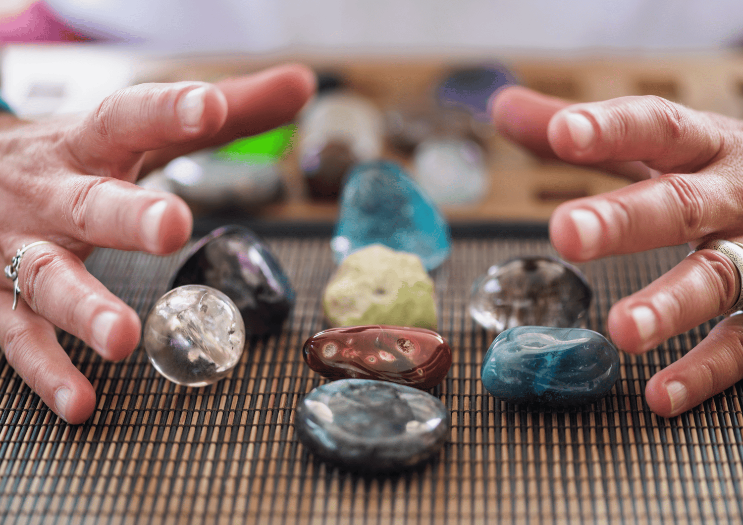 hands hovering over crystals