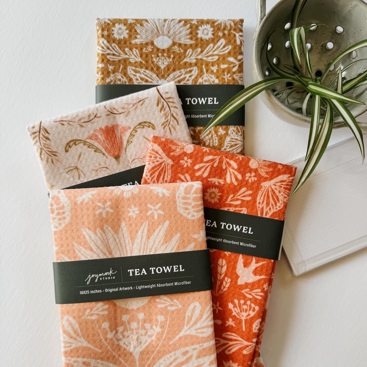 Collection of Mariposa Motif whimsical and refined tea towels with waffle weave texture and Joymark Studio packaging