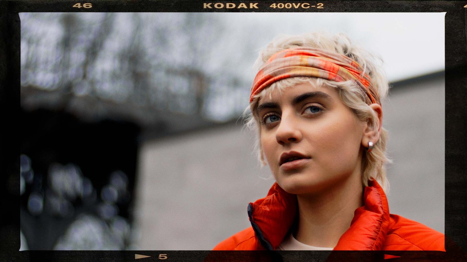 Perfect skin tones on a female model with an orange headband.