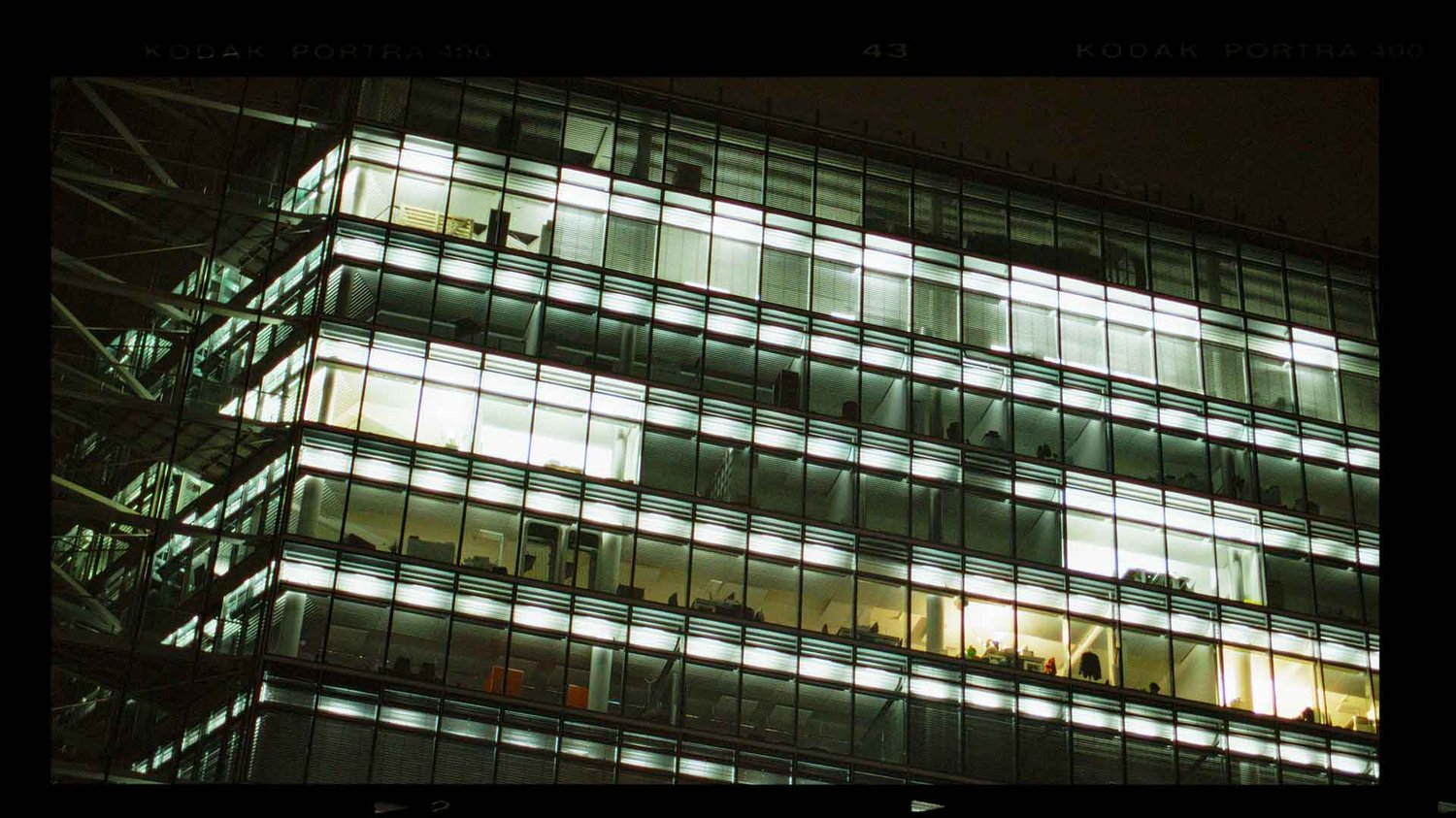 A city building is lit up at night.