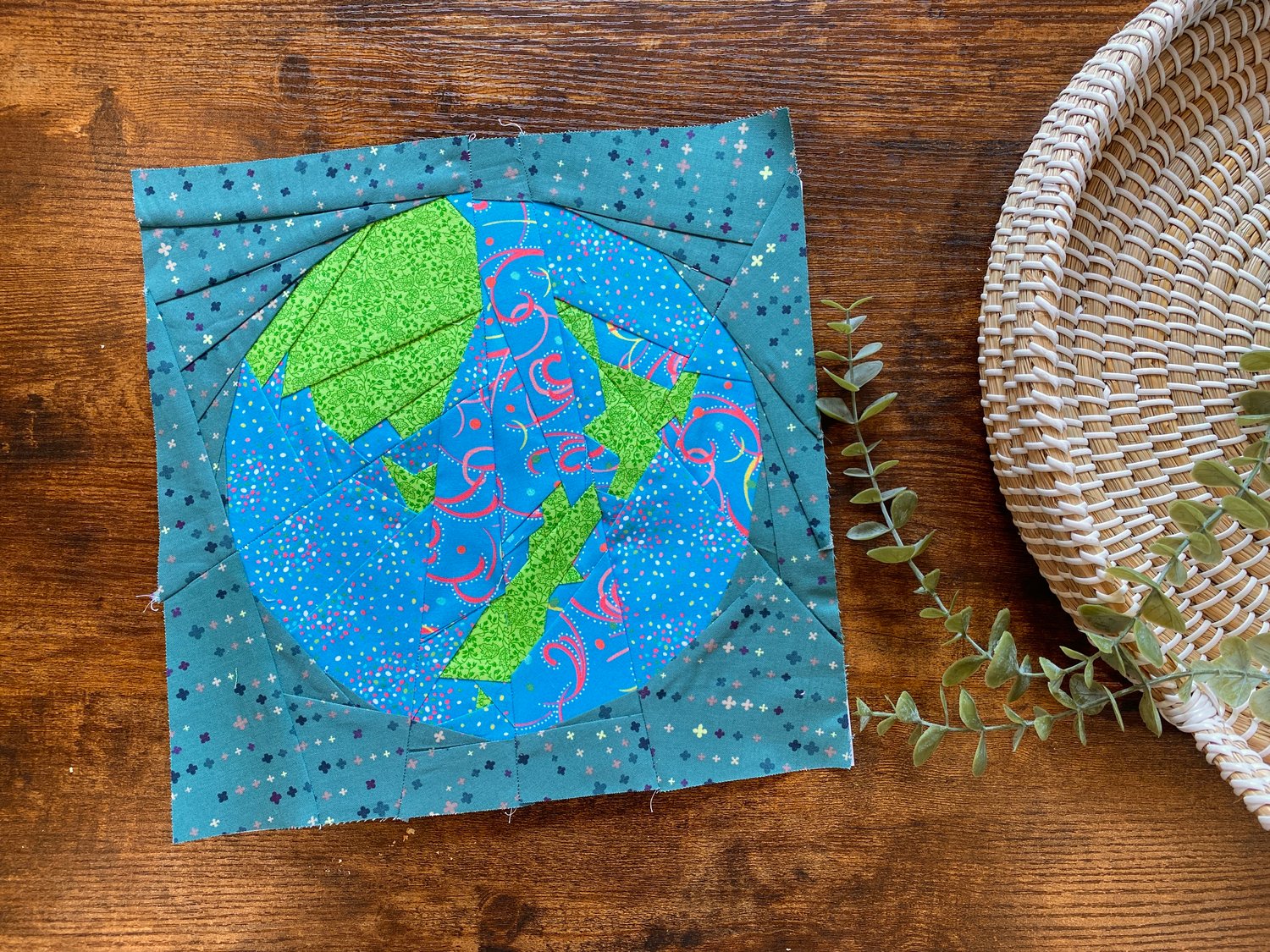 This is a photo of the finished paper pieced quilt block. Although I ran out of the blue fabric I had chosen, you can still see the contrast between the land and the sea on the Planet Earth,