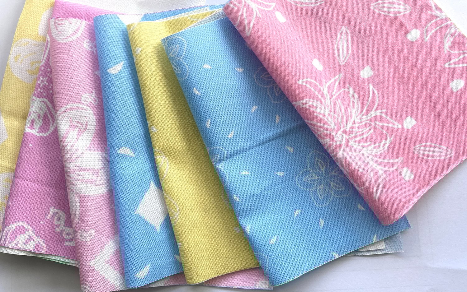 Vintage floral fabrics are great for quilting projects. These have white hand drawn flowers, pastel pinks and blues for background and are available on Spoonflower.