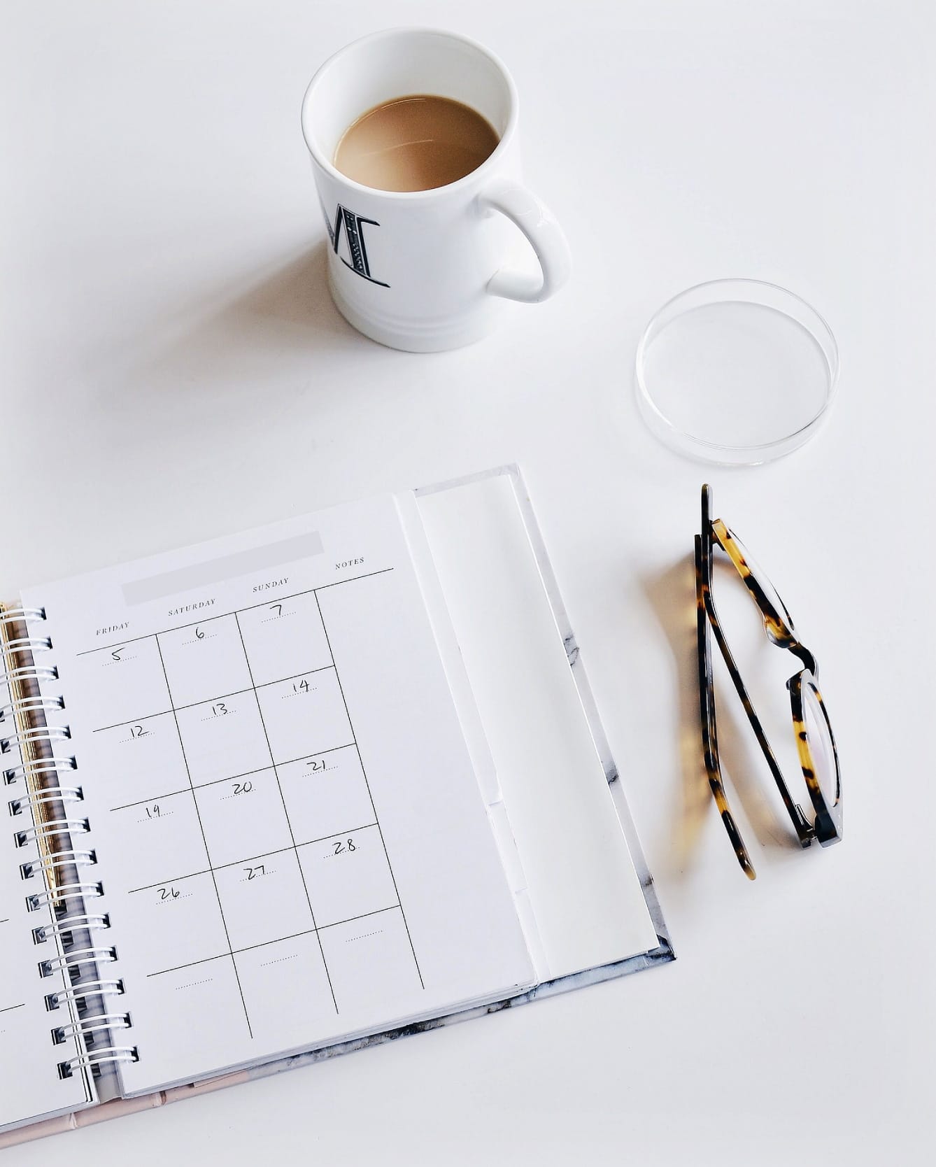 Day planner with cup of coffee and pair of glasses | The Musicpreneur Model for self-employed musicians and music freelancers by Ashley Danyew & Steve Danyew