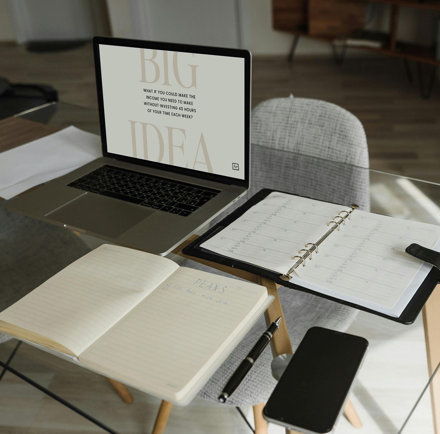 Laptop, day planner, and notebook on glass desk | The Musicpreneur Model for self-employed musicians and music freelancers by Ashley Danyew & Steve Danyew