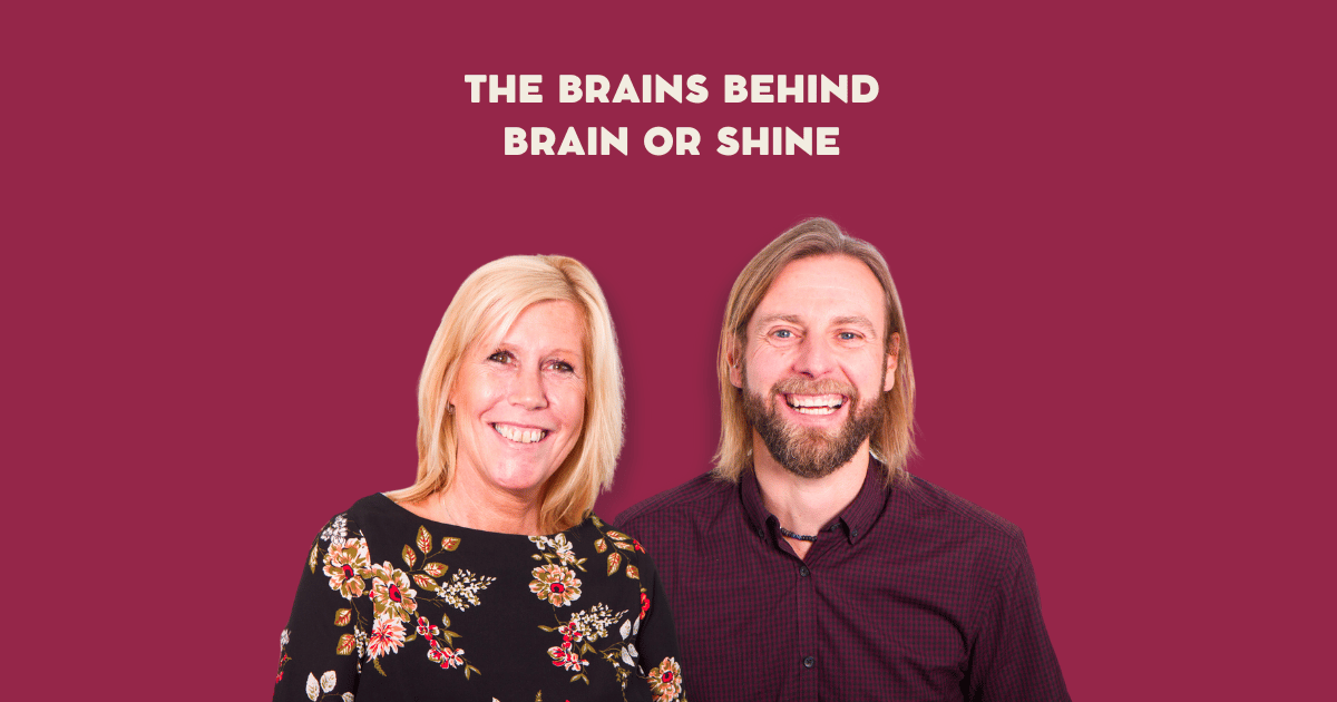 Creators of Brain or Shine, Jules and Mark. Both of looking happily at the camera. Mark holds his fist triumphantly in the air.