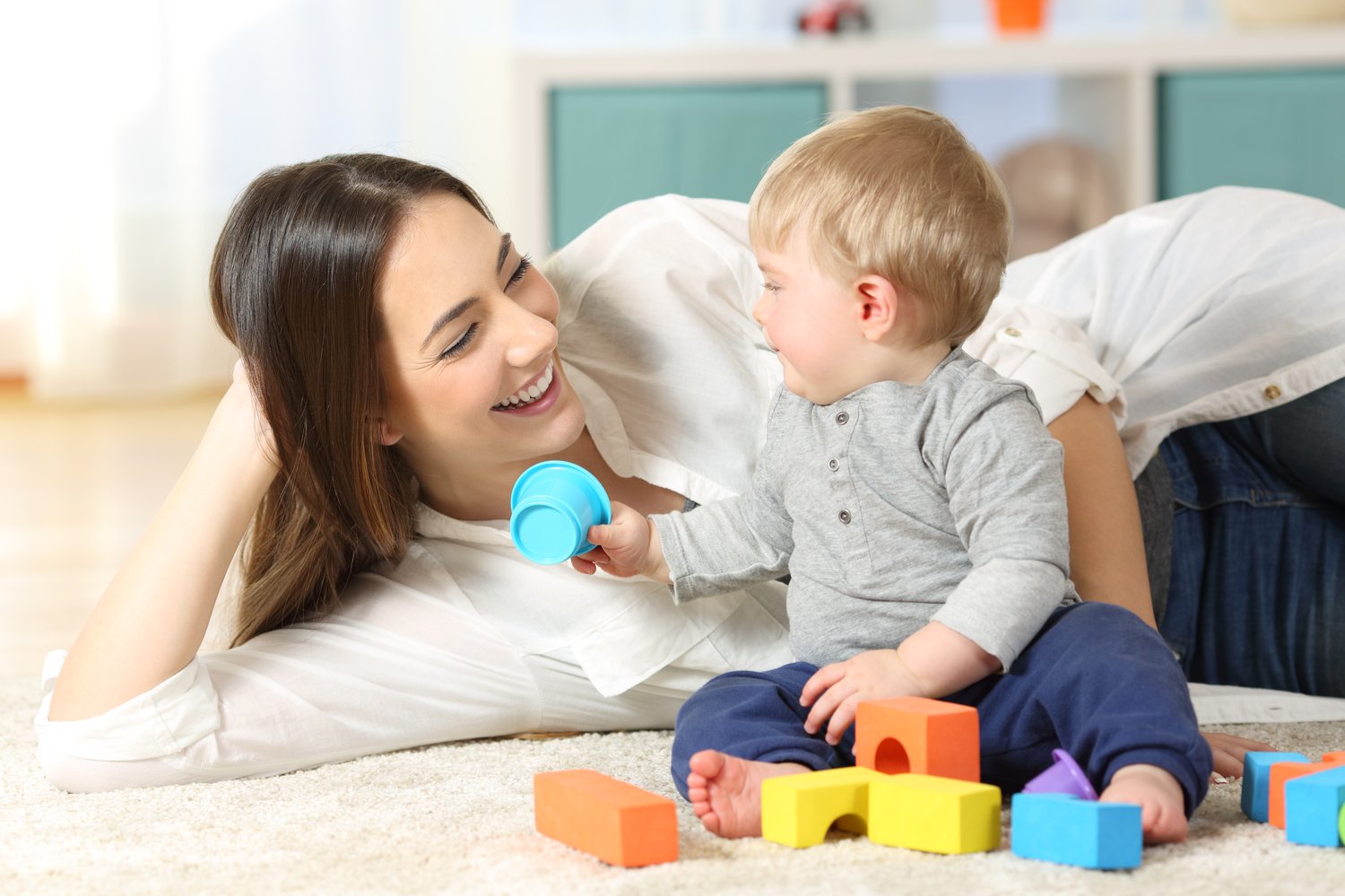 Mama playing on floor with baby