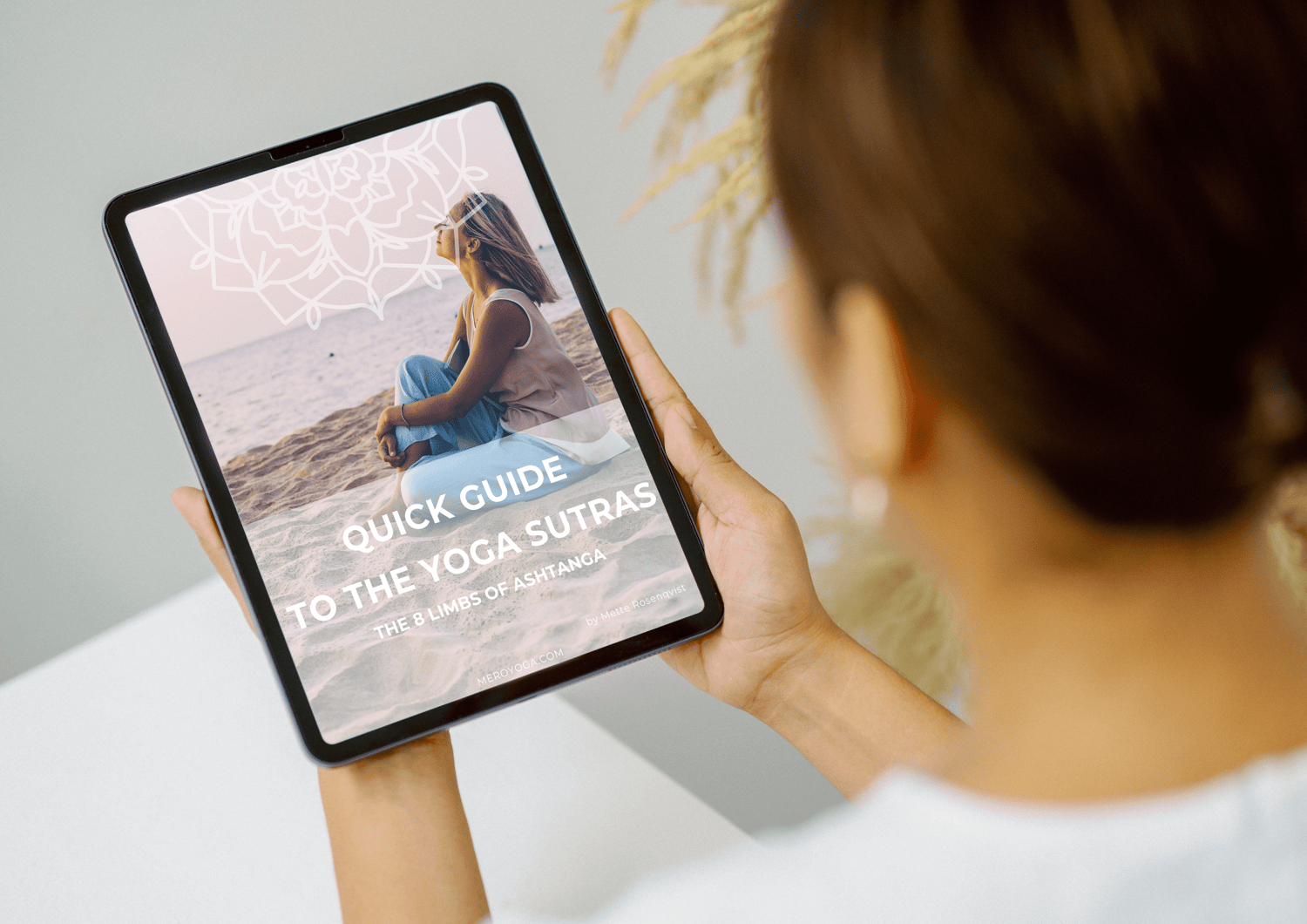 woman holding tablet with journal