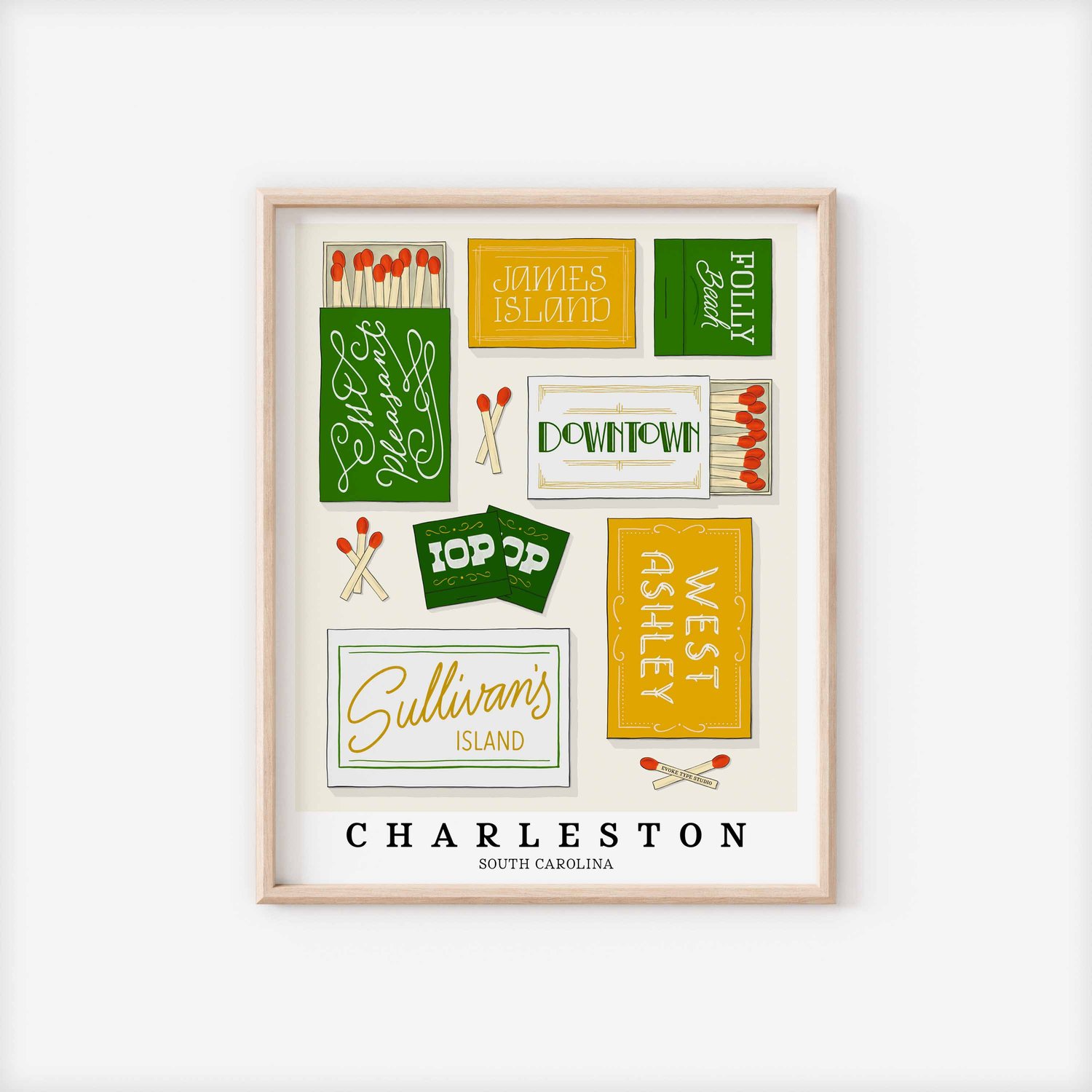 A framed picture of Charleston, South Carolina neighborhoods drawn in various lettering styles on matchboxes. Artwork has a green, yellow and white color scheme.