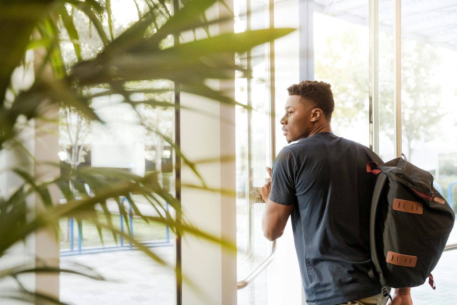 Black guy walking out of revolving door