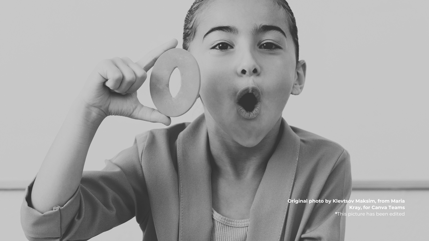 A girl demonstrating Spanish pronunciation of the letter O.