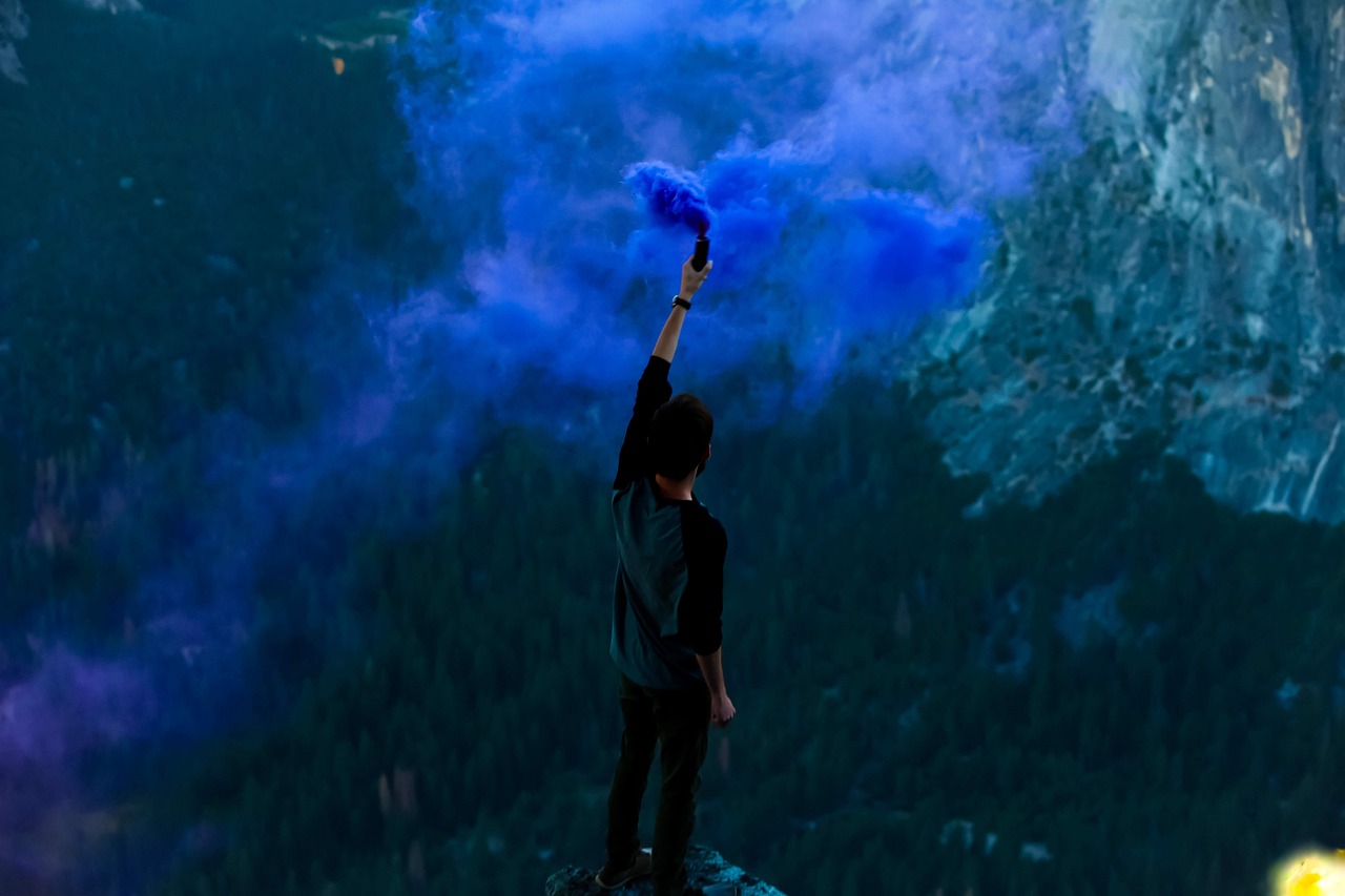 Azul, humo, instinto, montañas, chico con mano alzada
