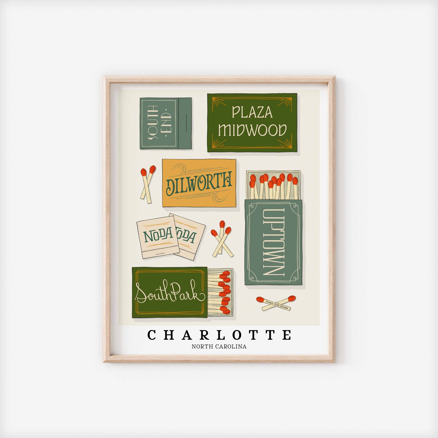 A framed picture of Charlotte, North Carolina neighborhoods drawn in various lettering styles on matchboxes. Artwork has a blue, green and yellow color scheme.