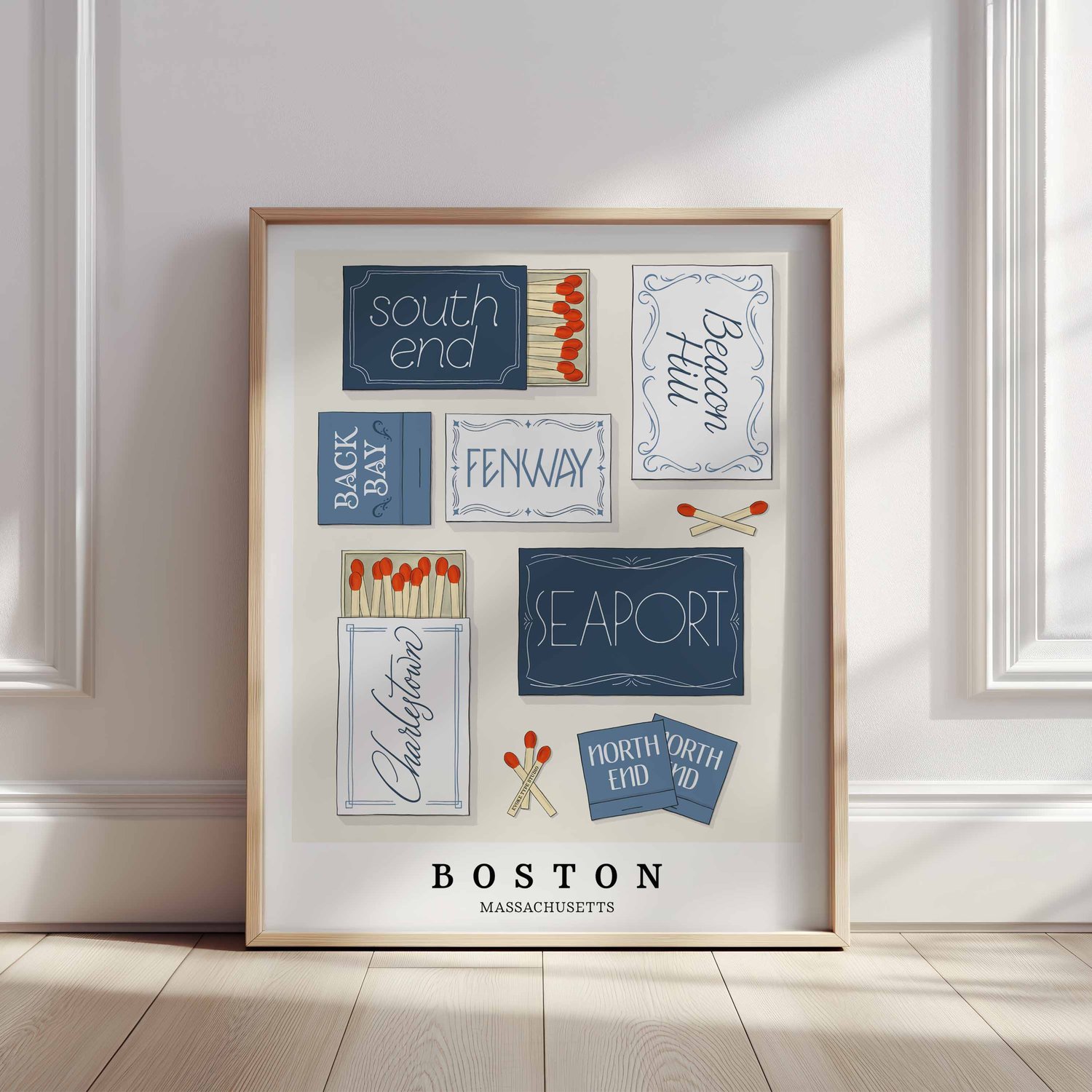 A framed picture of Boston, Massachusetts neighborhoods drawn in various lettering styles on matchboxes. Artwork has a blue and white color scheme