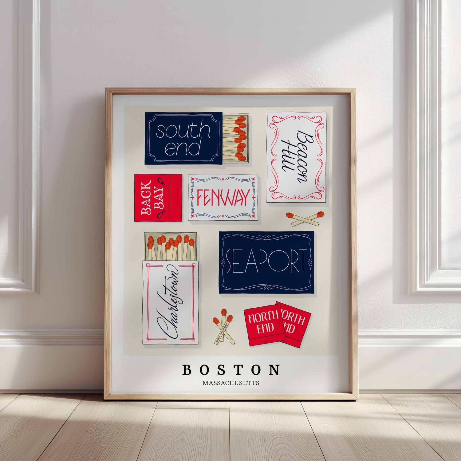 A framed picture of Boston, Massachusetts neighborhoods drawn in various lettering styles on matchboxes. Artwork has a red, white and blue color scheme