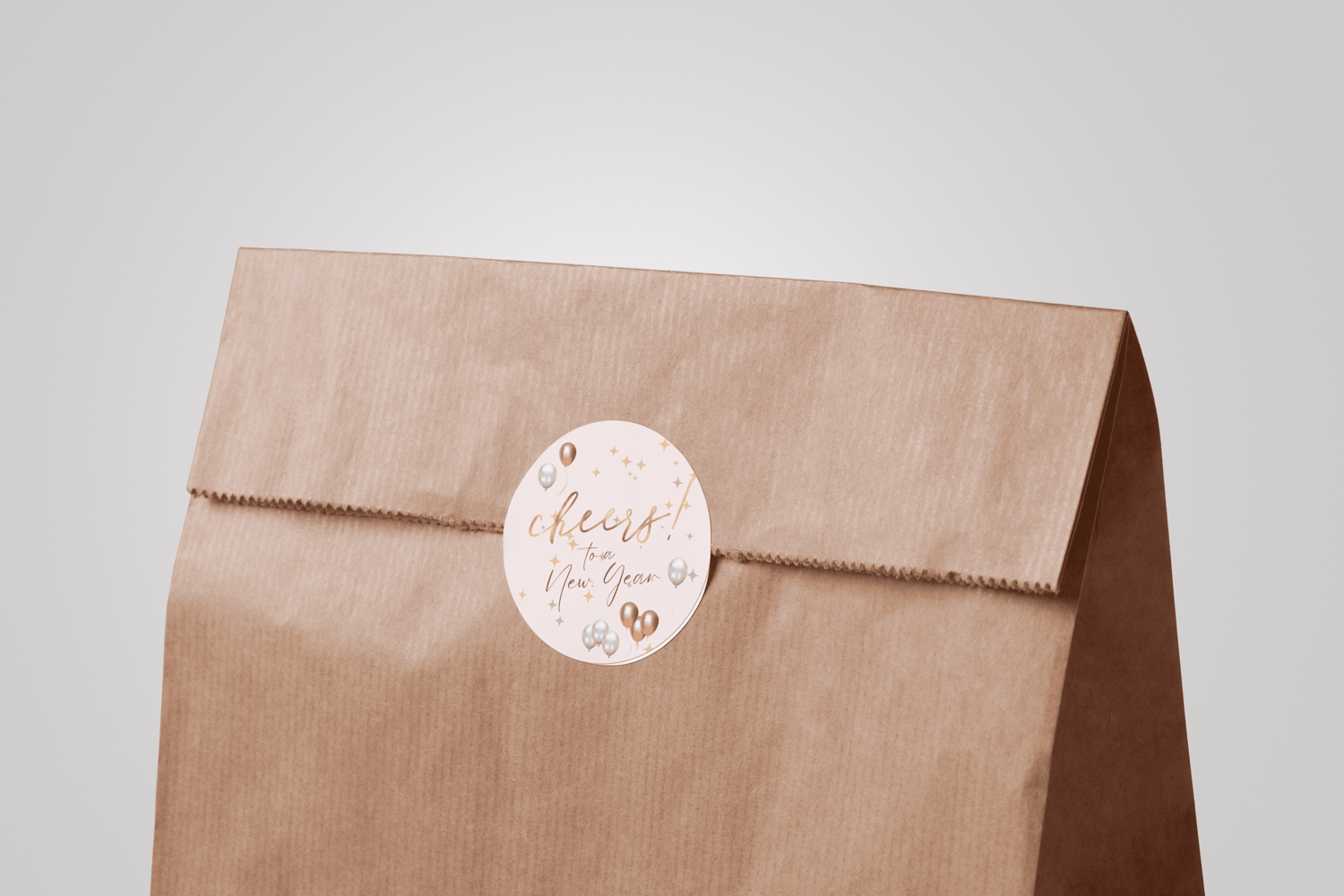 Customizable Cheers to New Year Celebration Circle Sticker | Digital Canva Template. Mock sticker on paper bag